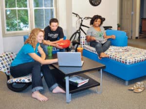 Students sitting on Rally and Trey Rocker while hanging out