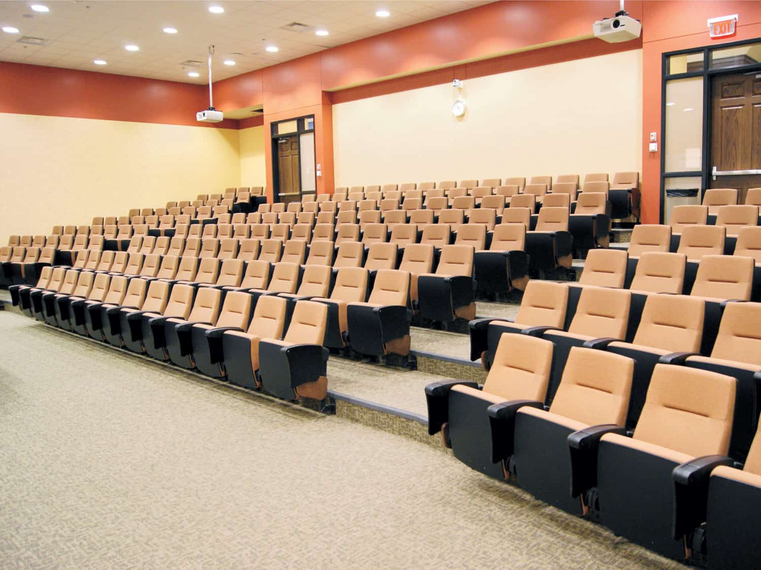 Clarity Auditorium Seating with tablet arms shown in a lecture hall