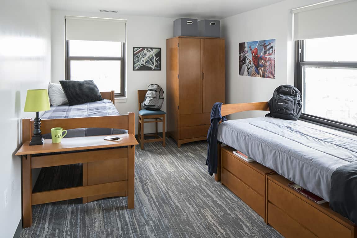 Dorm room with Beechwood desk, beds, stacking chests and wardrobe
