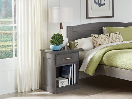 Wood nightstand in student room on college campus. class=